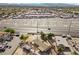 Aerial view of home with desert landscaping, carport, and a large commercial market in the distance at 2821 Geist Cir, Las Vegas, NV 89115