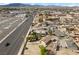 An aerial view of a desert home with city street in the foreground and a commercial shopping center at 2821 Geist Cir, Las Vegas, NV 89115