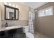 Modern bathroom with updated fixtures, a walk-in shower, sleek tiling, and vanity sink at 2821 Geist Cir, Las Vegas, NV 89115