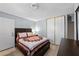 Well-lit bedroom with wood flooring and a closet with sliding doors for storage at 2821 Geist Cir, Las Vegas, NV 89115