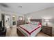 Charming bedroom with light wood floors, a dresser, and an open door to the en-suite bathroom at 2821 Geist Cir, Las Vegas, NV 89115