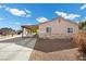 Side view of a house with a long driveway and a detached shed at 2821 Geist Cir, Las Vegas, NV 89115