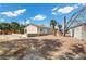 Exterior elevation of home surrounded by gravel, plants and blue sky above at 2821 Geist Cir, Las Vegas, NV 89115