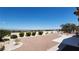 Expansive backyard with manicured hedges, desert landscaping, stone pavers, and city views at 2904 Bow Bridge Dr, Las Vegas, NV 89134