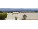 Well-manicured backyard featuring desert landscaping, a privacy wall, and city views at 2904 Bow Bridge Dr, Las Vegas, NV 89134