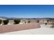 Backyard featuring rock landscaping, decorative stone path, lush bushes, and a privacy wall with mountain views at 2904 Bow Bridge Dr, Las Vegas, NV 89134