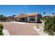 Back exterior of home with large patio and desert landscaping at 2904 Bow Bridge Dr, Las Vegas, NV 89134