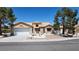 Charming single-story home featuring desert landscaping, a tile roof, and an attached two-car garage at 2904 Bow Bridge Dr, Las Vegas, NV 89134