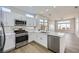 Modern kitchen with white cabinets, stainless steel appliances, and island sink at 2904 Bow Bridge Dr, Las Vegas, NV 89134