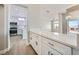 Bright kitchen with white cabinets, granite countertops, and stainless steel appliances open to the living area at 2904 Bow Bridge Dr, Las Vegas, NV 89134