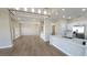 Bright, open living space featuring hardwood floors and a modern kitchen with stainless steel appliances at 2904 Bow Bridge Dr, Las Vegas, NV 89134