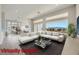 Spacious living area with modern decor, large windows showcasing mountain views, and access to dining area at 2904 Bow Bridge Dr, Las Vegas, NV 89134