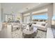 Bright, open-concept living room featuring a modern design, large windows, and mountain views at 2904 Bow Bridge Dr, Las Vegas, NV 89134