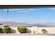 Expansive view of the mountains from the backyard, framed by lush greenery and a blue sky at 2904 Bow Bridge Dr, Las Vegas, NV 89134