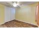 Bedroom featuring wood floors, a ceiling fan, and a large closet for storage at 3062 El Camino Ave, Las Vegas, NV 89102