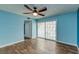 Bedroom with wood flooring, a ceiling fan, and sliding glass doors at 3062 El Camino Ave, Las Vegas, NV 89102