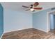 Light-filled bedroom featuring a ceiling fan and wood-look laminate floors at 3062 El Camino Ave, Las Vegas, NV 89102