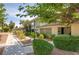 Well-maintained home featuring manicured landscaping, mature trees, and a charming exterior facade at 3062 El Camino Ave, Las Vegas, NV 89102