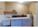 Functional laundry room with washer, dryer, sink, shelf and water heater at 3062 El Camino Ave, Las Vegas, NV 89102