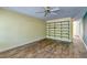 Bright living room featuring hardwood floors, a ceiling fan, and installed wall shelving at 3062 El Camino Ave, Las Vegas, NV 89102
