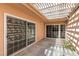 Secluded patio area with tile flooring and natural light from overhead pergola at 3062 El Camino Ave, Las Vegas, NV 89102