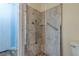 Tiled stand-up shower with grab bars and a stone floor adds accessibility and style to this bathroom at 3062 El Camino Ave, Las Vegas, NV 89102