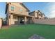 Spacious backyard features an artificial lawn and covered patio, perfect for entertaining at 361 Andy Wheeler Dr, Henderson, NV 89011