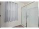 Bright bathroom featuring a tiled shower with glass doors and wood-look tile flooring at 361 Andy Wheeler Dr, Henderson, NV 89011