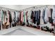 Walk-in closet featuring clothing racks and shelves filled with an extensive collection of clothing and shoes at 361 Andy Wheeler Dr, Henderson, NV 89011