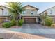 Charming two-story home with a well-manicured front yard and a brick driveway at 361 Andy Wheeler Dr, Henderson, NV 89011