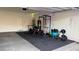 A well-equipped garage featuring exercise equipment, weights, and lighting at 361 Andy Wheeler Dr, Henderson, NV 89011