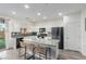 Modern kitchen with white cabinets, granite countertops, and a center island with seating at 361 Andy Wheeler Dr, Henderson, NV 89011
