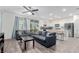 Bright living room with wood floors, ceiling fan and open-concept layout with access to the kitchen at 361 Andy Wheeler Dr, Henderson, NV 89011