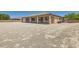 Wide backyard with a covered patio and block wall fence, creating a private outdoor retreat at 3910 Internet Ave, North Las Vegas, NV 89031