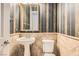 Chic half bath with pedestal sink and elegant striped wallpaper at 3910 Internet Ave, North Las Vegas, NV 89031