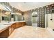 Large bathroom with dual sinks, decorative wallpaper, and walk-in shower at 3910 Internet Ave, North Las Vegas, NV 89031