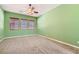Cozy bedroom featuring a ceiling fan, plush carpet, and three windows at 3910 Internet Ave, North Las Vegas, NV 89031