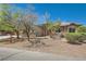 Charming single-story home featuring a stone facade, well-maintained landscaping, and desert surroundings at 3910 Internet Ave, North Las Vegas, NV 89031