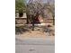 Front of home featuring a red door, desert landscaping, and stone accents at 3910 Internet Ave, North Las Vegas, NV 89031