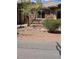 Home exterior featuring desert landscaping, stonework, and secure gated entry at 3910 Internet Ave, North Las Vegas, NV 89031