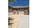 Three-car garage with stone accents and ample parking on a concrete driveway at 3910 Internet Ave, North Las Vegas, NV 89031