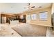 Spacious living room with neutral walls, tile flooring, and an open layout to the kitchen at 3910 Internet Ave, North Las Vegas, NV 89031