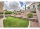 Spacious backyard featuring tiered landscaping and artificial turf lawn at 417 Carlton Kay Pl, Las Vegas, NV 89144
