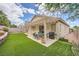 Well-maintained backyard with artificial turf, patio, and desert landscaping at 417 Carlton Kay Pl, Las Vegas, NV 89144