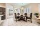 Charming dining area featuring a round table with upholstered chairs and ample natural light at 417 Carlton Kay Pl, Las Vegas, NV 89144