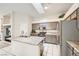 Modern kitchen with stainless steel appliances, a granite island, and white tile flooring at 417 Carlton Kay Pl, Las Vegas, NV 89144