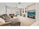Bright living room features a plush sectional, fireplace, and built-in shelving at 417 Carlton Kay Pl, Las Vegas, NV 89144