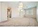 Open-concept living room with neutral carpet, light walls, and an elegant front door with side lights at 417 Carlton Kay Pl, Las Vegas, NV 89144