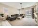 Comfortable living room with a large sectional sofa, a ceiling fan, and sliding glass doors to the backyard at 417 Carlton Kay Pl, Las Vegas, NV 89144