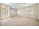 Spacious living room featuring plush carpeting, neutral walls, and ample natural light from shuttered windows at 417 Carlton Kay Pl, Las Vegas, NV 89144